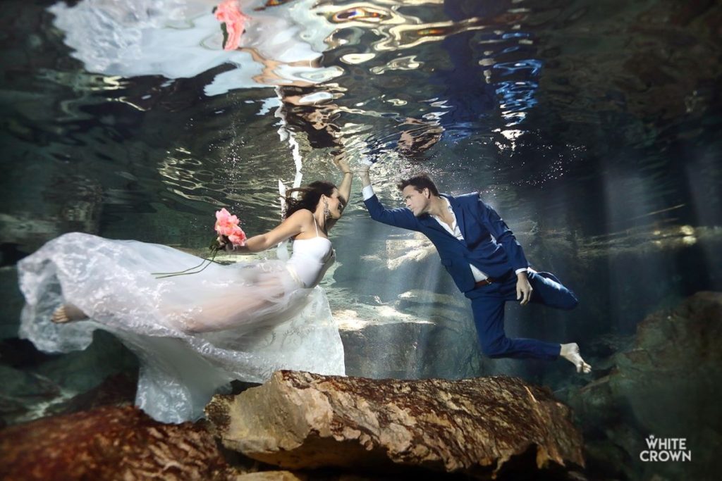 trash the dress photoshoot in a cenote in tulum captured by a destination wedding photographer