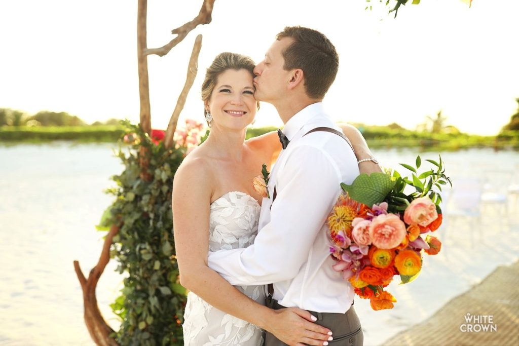 Just married couple holding each other after their wedding ceremony at fairmont mayakoba resort