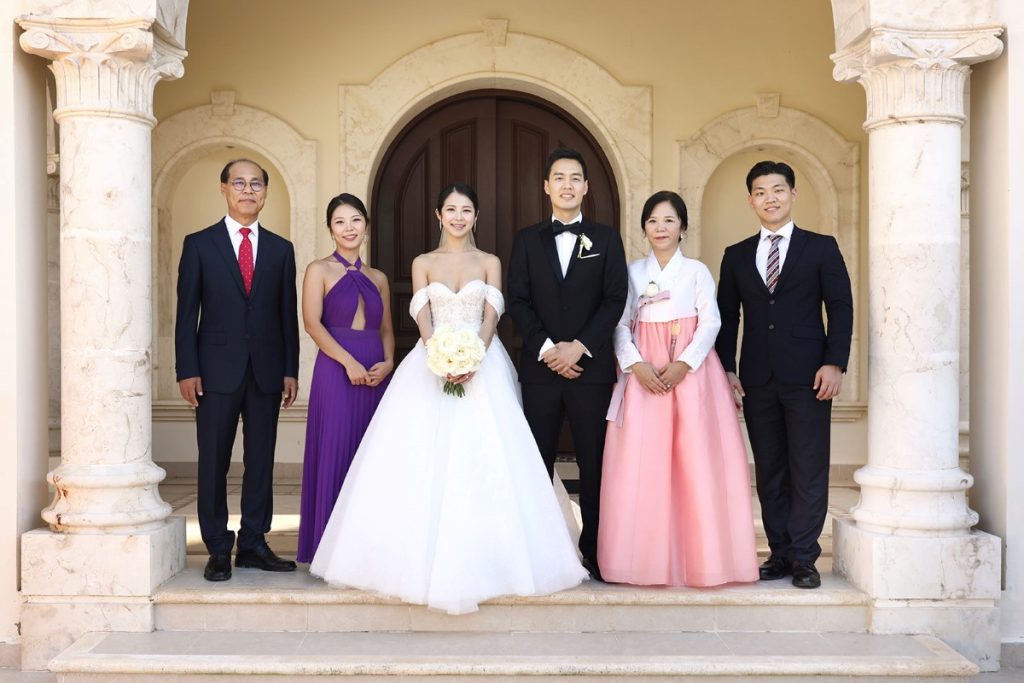 Wedding portrait of an Asian couple with their family