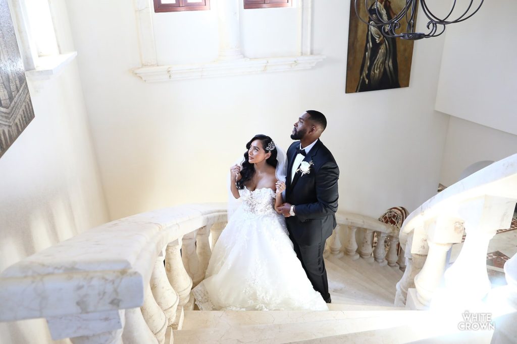 wedding couple posing in an elegant staircase