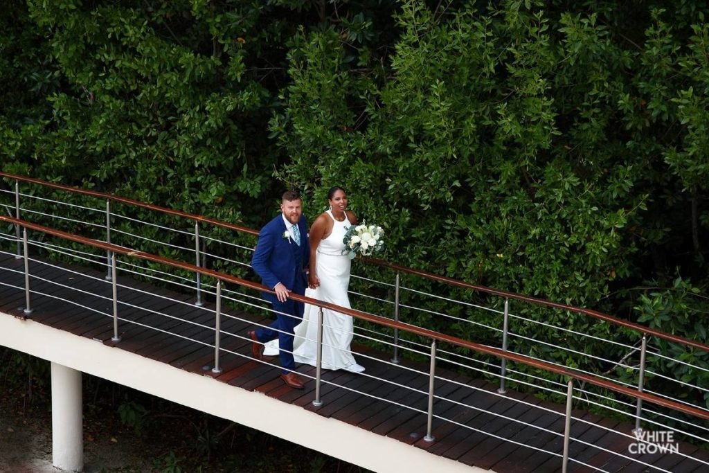 Wedding couple walking around lush tropical forest at a luxury resort in the riviera maya