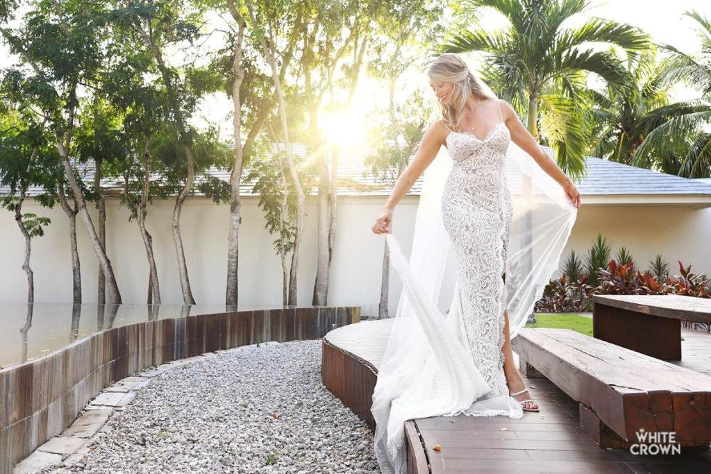 a bride posing at a sculpture garden in a luxury all inclusive wedding resort in mexico