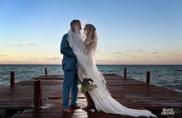 Wedding couple just married posing at the pier at blue diamond luxury boutique hotel wedding photography guide blog post