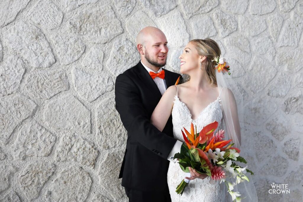 wedding couple posing for pictures during their wedding at hotel xcaret mexico